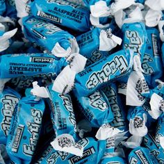 a pile of blue and white candies sitting on top of each other