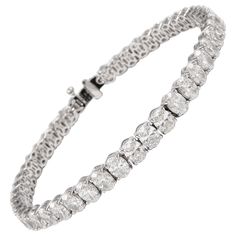 Stunning modern straight oval cut diamond tennis bracelet. High jewelry by Alexander Beverly Hills. 45 oval cut diamonds, 13.37 carats. Approximately F/G color and VS2/SI1 clarity. 18k white gold, 13.49 grams, 7 inches. Accommodated with an up to date appraisal by a GIA G.G., please contact us with any questions. Thank you. Item Number BS1692