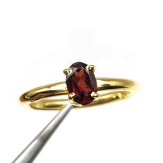 A gold-plated 925 silver ring adorned with a garnet gemstone is not only a stunning piece of jewelry but also carries significant birthstone specialties and healing properties. Garnet, the birthstone for January, is renowned for its deep red hue and multifaceted benefits. In terms of birthstone specialties, garnet is believed to enhance qualities associated with Capricorns and Aquarians, such as loyalty, trustworthiness, and self-discipline. It's said to bring good fortune and success to those born in January, encouraging them to pursue their goals with determination. From a healing perspective, garnet is thought to promote physical vitality and stamina, making it an ideal companion for those needing an energy boost. It's also considered a powerful emotional healer, assisting in the releas Heirloom Gold Garnet Rings, Gold Garnet Birthstone Ring, Gold Oval Garnet Birthstone Ring, Yellow Gold Garnet Rings With Prong Setting, Fine Jewelry Gold Garnet Rings, Gold Garnet Rings Fine Jewelry, Yellow Gold Garnet Rings For Gifts, Yellow Gold Garnet Ring With Polished Finish, Gold Garnet Open Ring