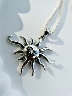 Illuminate your style with our Sterling Silver Boho Style Sun Pendant, beautifully paired with a whimsical popcorn link chain. The sun symbolizes warmth, positivity, and vitality, while the boho-inspired design adds a touch of free-spirited charm. Crafted from high-quality sterling silver, this necklace exudes both durability and timeless elegance. Perfect for adding a radiant glow to any outfit, it's a versatile piece that transitions effortlessly from day to night. Metal: 925 Sterling Silver. Silver Celestial Necklace With Sun Design, Sterling Silver Sun Design Spiritual Necklace, Silver Sun Necklace With Sun And Moon Design, Bohemian Sterling Silver Necklace With Sun Design, Silver Necklace With Sun And Moon Design, Silver Sun Design Necklace For Gift, Sterling Silver Bohemian Necklace With Sun Design, Silver Necklace With Sun Design For Gift, Silver Necklace With Sun Design As A Gift