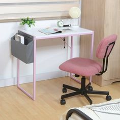 a desk with a pink chair next to it