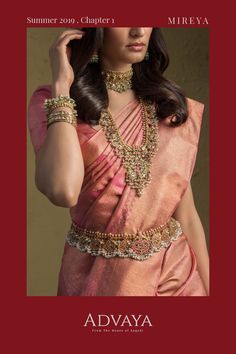 a woman wearing a pink sari and jewelry