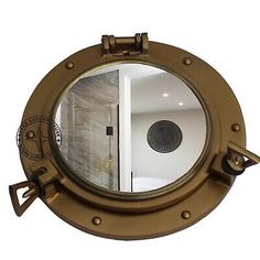 a porthole mirror is shown with an open door