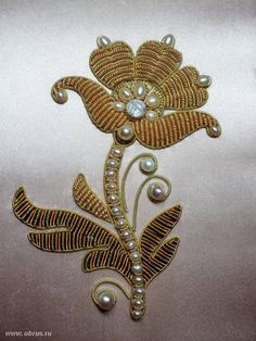 an embroidered design with pearls and leaves