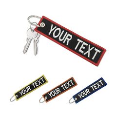 three keychains with the words your text printed on one side and two different color tags attached to each other