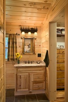 a bathroom with wooden walls and tile flooring