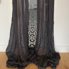 an open door with black sheer curtains on it