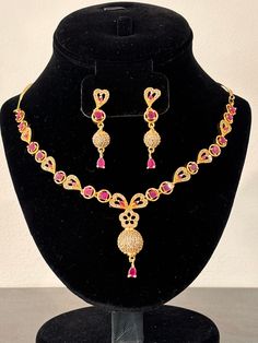 A stunning 3 piece Pakistani/Indian traditional necklace set.  Color: Ruby and Gold ideal for any occasion Disclaimer: The actual color of the item may vary from the pictures due to light effects. This type of jewelry is intended to be kept in a bag to prevent discoloration. Please avoid contact with water while wearing it. please notify us immediately about any Bollywood Style Elegant Jewelry For Gifts, Traditional Elegant Jewelry Sets For Gift, Traditional Elegant Jewelry Sets As Gift, Bollywood Style Intricate Jewelry Sets As Gift, Bollywood Style Jewelry Sets With Intricate Design As Gift, Bollywood Style Round Necklace For Gift, Bollywood Style Round Necklace As Gift, Elegant Pink Jewelry Sets For Diwali, Pink Necklace With Intricate Design For Festive Occasions