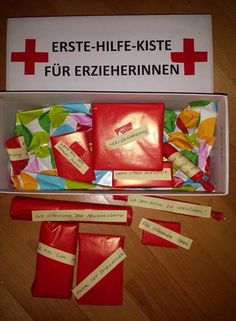 an open box filled with lots of red and yellow items on top of a wooden floor