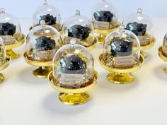 there are many snow globes that have been covered with gold and black glittery material