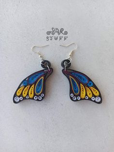 the butterfly earrings are made from glass and have been hand painted with colorful designs on them