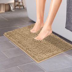 a person standing on a bath mat in a bathroom