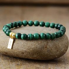 The Handmade Natural Malachite Beaded Bracelet with a Gold Plated Tag looks great. It will make the perfect gift 🎁 for someone special, or treat yourself as you deserve it 💖 🥰 These Bracelets have been made using high quality Natural Malachite and have a Gold Plated Tag with MC for MantraChakra. They are available as 4mm, 6mm and 8mm. Malachite is used as a protective gem due to its immense powers of protection. It is the stone of unconditional Love and Relationships and is a universal healin Luxury Green Malachite Bracelet, Bracelet Pierre Malachite, Luxury Malachite Jewelry With Polished Beads, Luxury Malachite Gemstone Beads Jewelry, Luxury Malachite Jewelry With Round Beads, Malachite Bracelet Ideas, Green 8mm Beads Bracelets As Gift, Green Malachite Beaded Bracelets As Gift, Green Stretch Bracelet With 8mm Beads As Gift