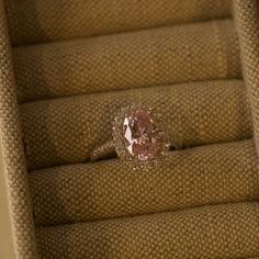 a pink diamond ring sitting on top of some steps