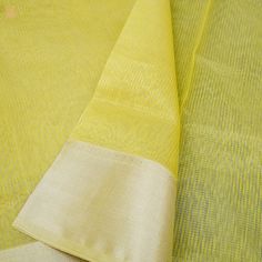 Khinkhwab brings you Maheshwari Sarees. Maheshwari handlooms owe their name to Maharani Ahilyabai Holkar, the ruler of the state of Indore in the late 18th century. Her reign was deemed the Golden Age, and she is revered by all at Maheshwar as Devi Ahilyabai or Ma Saab till date. Maheshwari handlooms derived their fine simplicity from this icon. It is said that under her artistic guidance, the craftspeople made light fabrics, detailed with motifs derived from carvings on the Maheshwar fort- a de Yellow Tussar Silk Dupatta With Border, Yellow Dupatta With Border For Puja, Yellow Chanderi Traditional Wear With Border, Yellow Border Dupatta For Puja, Festival Cotton Silk Dupatta With Border, Yellow Dupatta With Border For Diwali, Slub Silk Dupatta With Border, Tissue Silk Dupatta With Border For Puja, Yellow Cotton Silk Dupatta For Puja