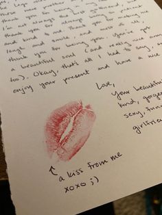 a handwritten letter with a red lip on it