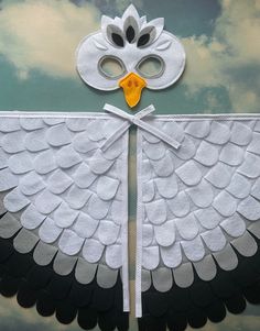 a white and black bird with yellow beaks on it's wings in the sky