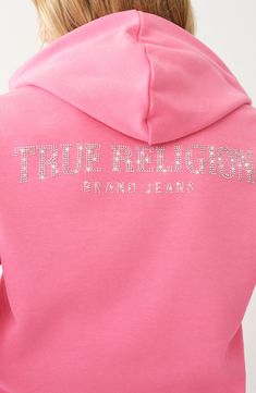 A logo of shimmering rhinestones spans ths back of this zip-up hoodie to bring a touch of glam to your everyday look. 23" length Front zip closure Drawstring hood Split kangaroo pocket 60% cotton, 40% polyester Machine wash, line dry Imported Baby Pink Zip Up Hoodie, Streetwear Hoodie With Rhinestones, Rhinestone Hooded Hoodie For Streetwear, Hooded Rhinestone Hoodie For Streetwear, Rhinestone Hoodie For Streetwear, Fall Hoodie With Rhinestones, Winter Streetwear Hoodie With Rhinestones, Winter Rhinestone Hoodie For Streetwear, Winter Hoodie With Rhinestones