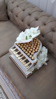 a tray filled with lots of food sitting on top of a couch next to flowers