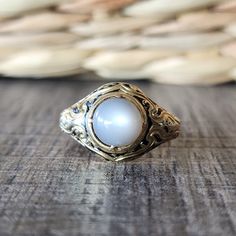 Antique 1846 Victorian Moonstone Cabochon Ring with Black Enamel in 18k Yellow Gold | Mourning Ring | Memorial Jewelry Phenomenal estate moonstone ring for the discerning collector.  This late Georgian/ Early Victorian era piece is fashioned from substantial 18k yellow gold, and features a cabochon cut moonstone with black enamel detailing.  The moonstone has a creamy color with grays. This is a memorial ring and the inscription reads: Robert Burra born 25 april 1767, died 28 Jan 1846. DETAILS/MEASUREMENTS: Moonstone - about 8 mm  Face - 13.5 mm wide in the center Shank - 3.10 mm in back Height- 8.15 mm Weight -6.36 grams Hallmarks/Stamps - Faded/partial London mark and partial mark remaining of Victoria duty for 18k gold.  Currently a size 9- Can be resized by your jeweler or by ours for Luxury Vintage Moonstone Oval Cabochon Ring, Luxury Antique Cabochon Pearl Ring, Luxury Engraved Oval Cabochon Jewelry, Heirloom Yellow Gold Moonstone Cabochon Ring, Luxury Polished Oval Cabochon Moonstone Ring, Luxury Polished Moonstone Ring With Oval Cabochon, Luxury Oval Cabochon Moonstone Ring With Polished Finish, Elegant Gold Domed Cabochons, Hallmarked Yellow Gold Moonstone Ring