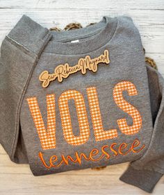 This beautiful Tennessee Volunteers embroidery appliqué design is the perfect addition to anyone's fall and winter wardrobe and perfect for those cool weather SEC football games! This LAT apparel tunic style crewneck sweatshirt features a drop-shoulder, ribbed cuffs and bottom band, raw edge seam at sleeve cuffs and bottom band, and a longer length silhouette with drop tail curved bottom hem. Choose between heathered granite or heathered natural sweatshirt - listing photo is heathered granite color *WASH AND CARE: - Wash in cold water on gentle cycle - Hang to dry or Tumble dry low - Use a warm iron if needed for any wrinkles *RETURNS & EXCHANGES: Due to the personalization of our items we cannot accept returns. If we make a mistake we will gladly issue a refund or ship out a replacement. Tennessee Embroidery Designs, Tn Vols Gameday Outfit Women, Embroidered Tops For College In Fall, Embroidered Graphic Tops For College In Fall, Embroidered Fall College Top, Fall Tops With School Spirit Letter Embroidery, Fall College Top With Embroidered Graphics, Embroidered Logo Tops For Game Day In Fall, Embroidered School Spirit Tops For Fall