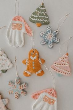 some ornaments are hanging from strings on a table