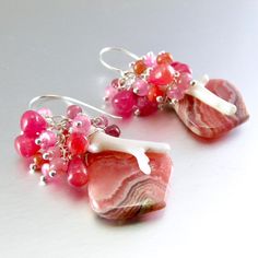 I love these focals! They are Argentine rhodochrosite gems and measure 22x20mm. They have been wrapped in sterling silver wire and dangle below a gorgeous combination of smooth ruby briolettes, pink moonstone, pink sapphire, white branch coral. Each bead is meticulously wrapped onto it's own head pin. The entire cluster is topped. I have used simple sterling ear wires. The earrings measure 1 3/4 (44mm.) from the top of the ear wires. Unique Pink Gemstone Earrings, Sterling Silver Pink Wire Wrapped Earrings, Pink Sterling Silver Wire Wrapped Earrings, Pink Gemstones For Gifts, Unique Pink Sterling Silver Earrings, Unique Pink Gemstones For Gifts, Pink Natural Stones Gemstones In Sterling Silver, White Branches, Black Freshwater Pearls