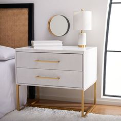 a white nightstand with two drawers and a round mirror on the wall next to it