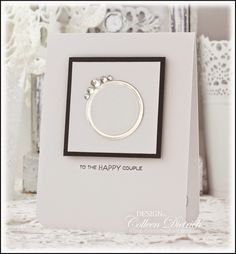 a white card with a silver ring on it