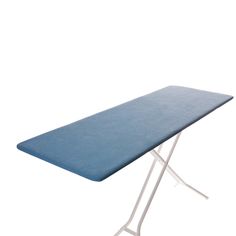 a blue ironing board sitting on top of a white table