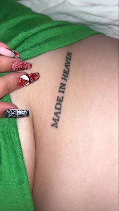 a woman with red and white nail polish on her stomach has the words made in heaven written across her left breast