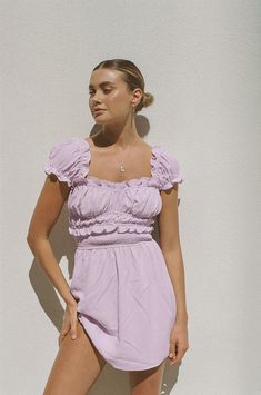 *THIS IS A FINAL SALE ITEM and cannot be returned. See our Returns Policy here A feminine, easy-to-wear Yulia Dress is made from a stunning lightweight fabric in a soft lilac hue. It features cap sleeves, ruffle details at sleeves, neckline and waist, shirring at waist and a flouncy skirt. Accessorise with 18K Zephyr Drop Huggies and Petal Necklace! Designed exclusively by Sabo. Cream Bodysuit, Flouncy Skirt, Shirred Dress, Maxi Bridesmaid Dresses, Sabo Skirt, Comfy Dresses, Lilac Purple, 50's Dress, Corset Dress