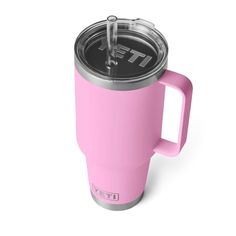 a pink yeti coffee cup with a lid and straw in the bottom, on a white background