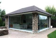 a patio area with stone and glass walls