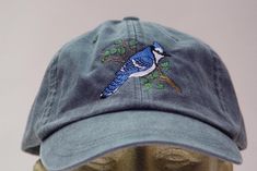 NEW EMBROIDERED BLUE JAY BIRD MEN WOMEN WILDLIFE BASEBALL HAT (HATS SHOWN ARE NAVY, LIME GREEN, KHAKI, PERIWINKLE BLUE, BURGUNDY, MUSTARD, CHARCOAL AND ROYAL BLUE) Adams Optimum 6 Panel Baseball Hat Low Profile - 100% Cotton Twill Adult Cap Pigment Dyed - Garment Washed Hat 6 Panels with Sewn Matching Eyelet Visor with 3 Rows of Stitching Pre-formed Bill - Leather Strap with Brass Grommet Adjustable - One Size Fits Most An Extremely Comfortable Baseball Hat! Enjoy the Embroidered Blue Jay Bird H Batfam Aesthetic, Soft Boy Outfits, Embroidery Apparel, Bird Hat, Blue Jay Bird, How To Wash Hats, Stephanie Brown, Jay Bird, Embroidery On Clothes