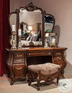 a dressing table with a mirror and stool