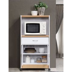 a microwave oven sitting on top of a wooden shelf next to a potted plant