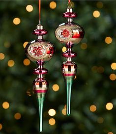 two glass ornaments hanging from a christmas tree