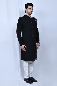 Black full sleeve sherwani with thread placement embroidery in floral pattern. Paired with cream straight pant.
Components: 2
Pattern: Embroidered
Type Of Work: Thread, floral
Neckline: Mandarin collar
Sleeve Type: Full sleeves
Fabric: Sherwani: Terry Rayon, Pant: Art Silk
Color: Black
Other Details: 
Front button detailing
Elasticated waistband
Side pockets
Occasion: Sangeet - Aza Fashions Elegant Designer Wear Sherwani With Straight Kurta, Elegant Sherwani With Dabka On Straight Kurta, Elegant Long Sleeve Churidar For Designer Wear, Unstitched Elegant Straight Kurta Sherwani, Elegant Straight Kurta Sherwani For Eid, Elegant Unstitched Sherwani With Straight Kurta, Eid Elegant Sherwani Straight Kurta, Elegant Eid Sherwani In Straight Kurta Style, Elegant Sherwani For Eid With Straight Kurta