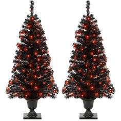 two artificial christmas trees with red lights on them