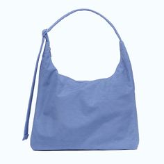 A blue nylon shoulder bag with an adjustable strap. Nylon Shoulder Bag, The Shade, Blue Hues, A Place, Shoulder Bag, Blue