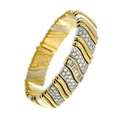 This Mid-Century Italian Cuff Bracelet is a stunning piece of jewelry that seamlessly blends elegance with geometric sophistication. Crafted with meticulous attention to detail, the bracelet is composed of a harmonious combination of yellow and white gold, showcasing a mesmerizing play of colors. The materials used in this piece are of the highest quality, with the bracelet being crafted from 18-karat gold. The design of the bracelet is characterized by its geometric lines, reminiscent of waves Elegant Flexible Diamond Bangle Bracelet, Modern Cuff Bracelet With Diamond Accents For Formal Events, Formal Diamond Bangle Bracelet With Oyster Detail, Modern Flexible Bracelets For Anniversary, Modern Bracelets For Anniversary, Modern Formal Bracelets With 17 Jewels, Luxury Flexible Bangle Cuff Bracelet, Elegant Formal Cuff Bracelet With Oyster Design, Modern Diamond Bangle Bracelet With Bracelet Strap