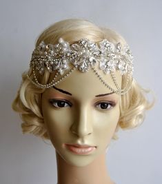 a mannequin wearing a headpiece with pearls and beads on it's head