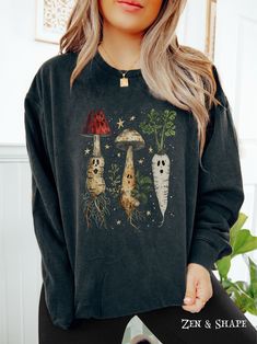 Spooky Cottagecore Shirt, Witchy Ghost Herbology T-Shirt, Mushroom Vegetable Gardening Sweatshirt, Botanical Nature Tee Gift For Plant Lover Color: Black Embrace your love for all things floral, cottagecore, and summer-inspired with our Comfort Colors lightweight crewneck sweatshirt. Made from 100% ring-spun cotton, this sweatshirt is as soft as a summer breeze and perfect for those cozy evenings spent surrounded by your favorite blooms. Product Details: - 100% ring-spun cotton - Light fabric (6 Casual Long Sleeve Top With Mushroom Design, Black Crew Neck Top With Mushroom Print, Relaxed Fit Fall Tops With Mushroom Print, Relaxed Fit Top With Mushroom Print For Fall, Relaxed Fit Mushroom Print Top For Fall, Fall Mushroom Design Crew Neck T-shirt, Fall Crew Neck T-shirt With Mushroom Design, Fall Crew Neck T-shirt With Mushroom Print, Mushroom Print Crew Neck Graphic Tee