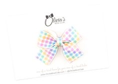 Hop into style this Easter with our eggs-traordinary Easter Collection! Cuter than a cottontail and great in an Easter basket, these adorable Antionette-style bows will have your little lady bunny-hopping for joy! *Due to the nature of our handmade bows and the patterns on the fabric, each bow may vary slightly. **Our bows may contain small parts that could potentially be dangerous to children. Please make sure your bow babe is supervised while wearing our bows at all times. Cute Satin Bow For Spring, White Bow Tie Hair Accessories For Summer, Cute White Ribbon Bow, Cute White Bow With Ribbon, White Ribbon Bow For Spring, White Summer Bow For Gifts, Playful White Bow With Matching Headband, Cute Adjustable Bow For Spring, Decorative Bow For Spring Gifts