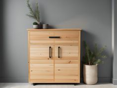 a wooden cabinet sitting next to a potted plant on top of a hard wood floor