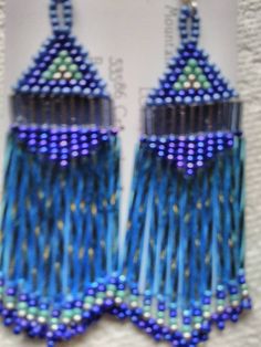 These Earrings are Handmade by Me. Native American, 5 shades of Blue, Blue Iris, Turquoise Iris, Metallic Silver, Czech Seed Beads size 11. 2 mm Silver Lined Bugle Beads "Smokey Blue" and "30mm Silver Lined Twisted Light Blue Bugle Beads with Fringe. They are 3 inches long and 1 and 1/4 inches wide. They are on Sterling Silver Hook Wires with Rubber Backs. They are Dangle Type Pierced Earrings, Handmade. I have one pair in stock. Made to Order means I will make a pair for you within 3 days after Blue Long Drop Chandelier Earrings, Blue Long Drop Beaded Earrings As Gift, Blue Long Drop Beaded Earrings For Gift, Blue Earrings With Dangling Beads, Unique Blue Earrings With Dangling Beads, Blue Long Drop Chandelier Earrings As A Gift, Unique Blue Long Drop Earrings, Beaded Earrings Native American, Earrings Native American