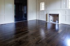 an empty room with hard wood floors and white paneling on the walls is shown