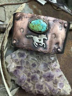 Made to order! All turquoise varies in color and size. Running free cuff bracelet by Weathered Soul, horse lover, equestrian, cowgirl, rustic cuff, artisan cuff, horse cuff, turquoise cuff, USA. Bronze snap set at approx. 7 and 8 inches. Copper hammered and riveted to recycled leather distressed black belt with sterling horse and sterling bezel set turquoise matrix stone. Artisan made in the USA. Please feel free to convo me with any questions.  Note*  Listing is just for the horse cuff. Other cuffs sold separately. Handmade Western Style Turquoise Bracelet, Handmade Western Turquoise Bracelet, Handmade Western Turquoise Bracelets, Handmade Artisan Jewelry For Rodeo, Western Patina Cuff Bracelet Gift, Artisan Concho Cuff Bracelet As Gift, Artisan Cuff Bracelet With Concho As Gift, Adjustable Western Cuff Bracelet With Patina, Unique Concho Cuff Bracelet For Gift