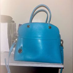 Never Used Furla Bag Light Blue Top Handle Bags For Office, Elegant Light Blue Bag For Daily Use, Light Blue Office Bag With Detachable Strap, Elegant Light Blue Top Handle Bag, Luxury Blue Top Handle Bag, Luxury Blue Handheld Satchel, Light Blue Tote Bag With Detachable Handle, Light Blue Tote Bag For Office, Elegant Light Blue Top Handle Satchel